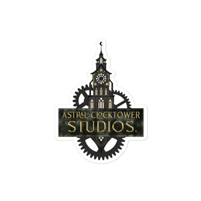 small vinyl kiss cut sticker featuring astral clocktower studios clock tower logo with gold font white background